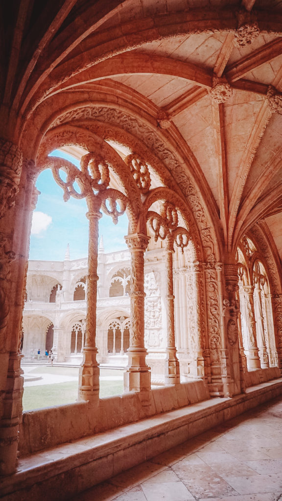The hall of the jeronimos monastery featuring one of its open walls with cloisters, one of the most interesting to see within 2 days in Lisbon Portugal
