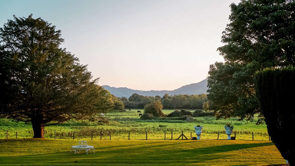 Peaceful gardens with mature trees, open lawns and mountain views surrounding the historic estate near Killarney.