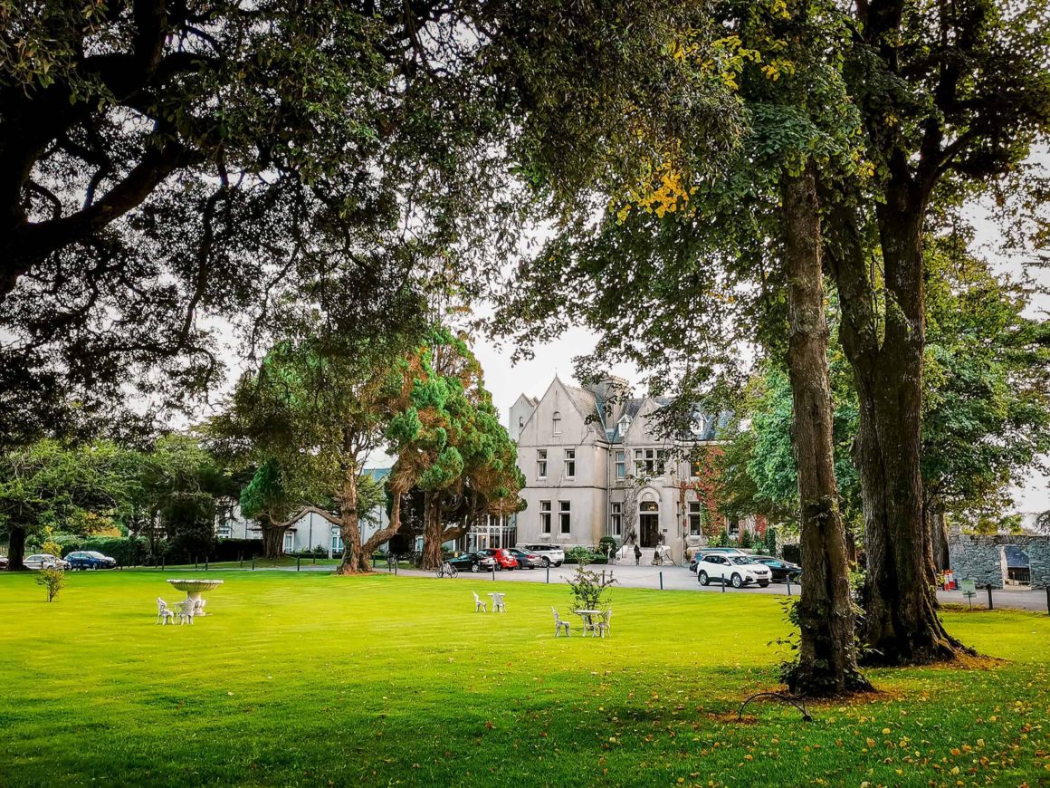 Expansive lawns, mature trees and the historic manor house set within the picturesque grounds of Cahernane House Hotel.