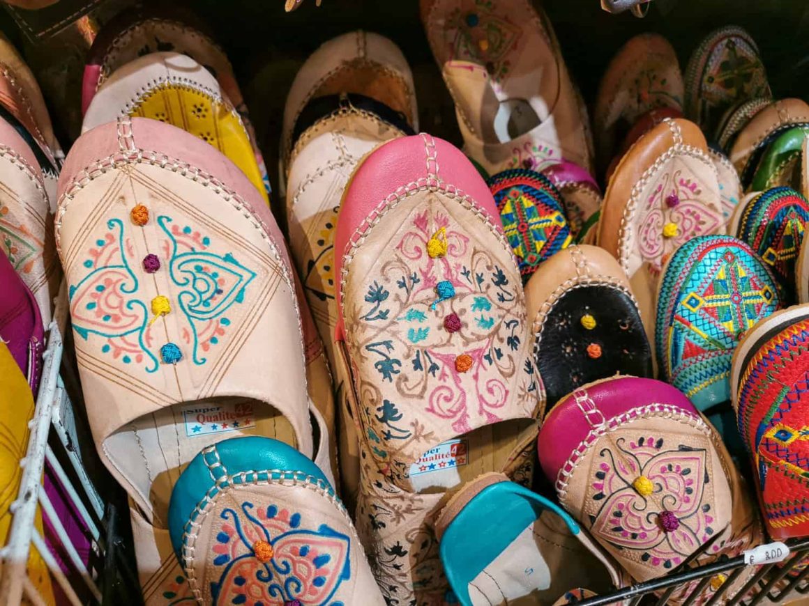 Colourful embroidered leather slippers displayed for sale at a shop in Seville, Spain.