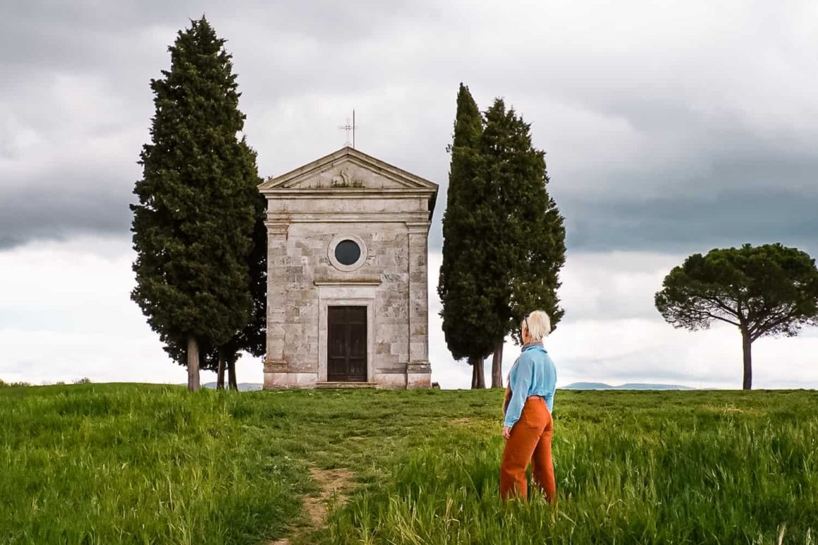 Traveller admiring the Chapel of the Madonna di Vitaleta in the Val d'Orcia countryside