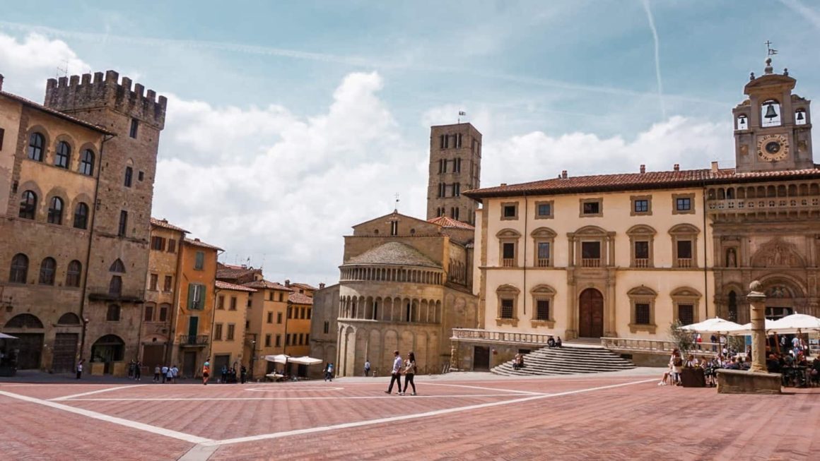 Piazza Grande in Arezzo with historic churches and palaces featured in a Tuscany road trip guide