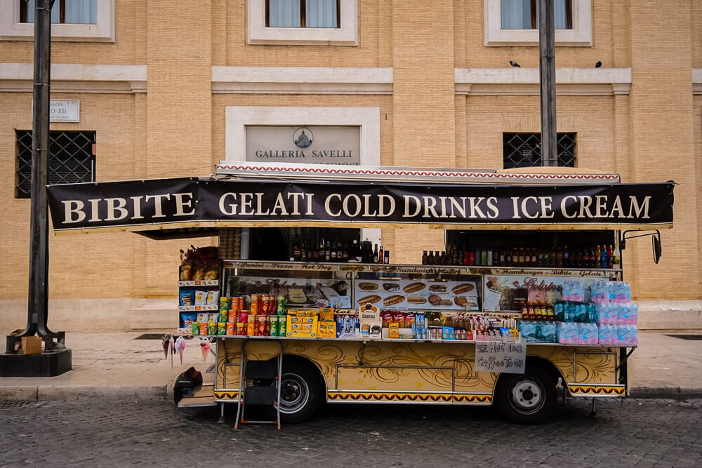 cart in rome selling newspapers, ice-cream and cold drinks