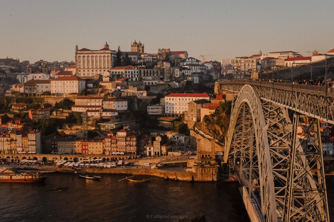 View of the Dom Luis I bridge over a body of water with a city in the background