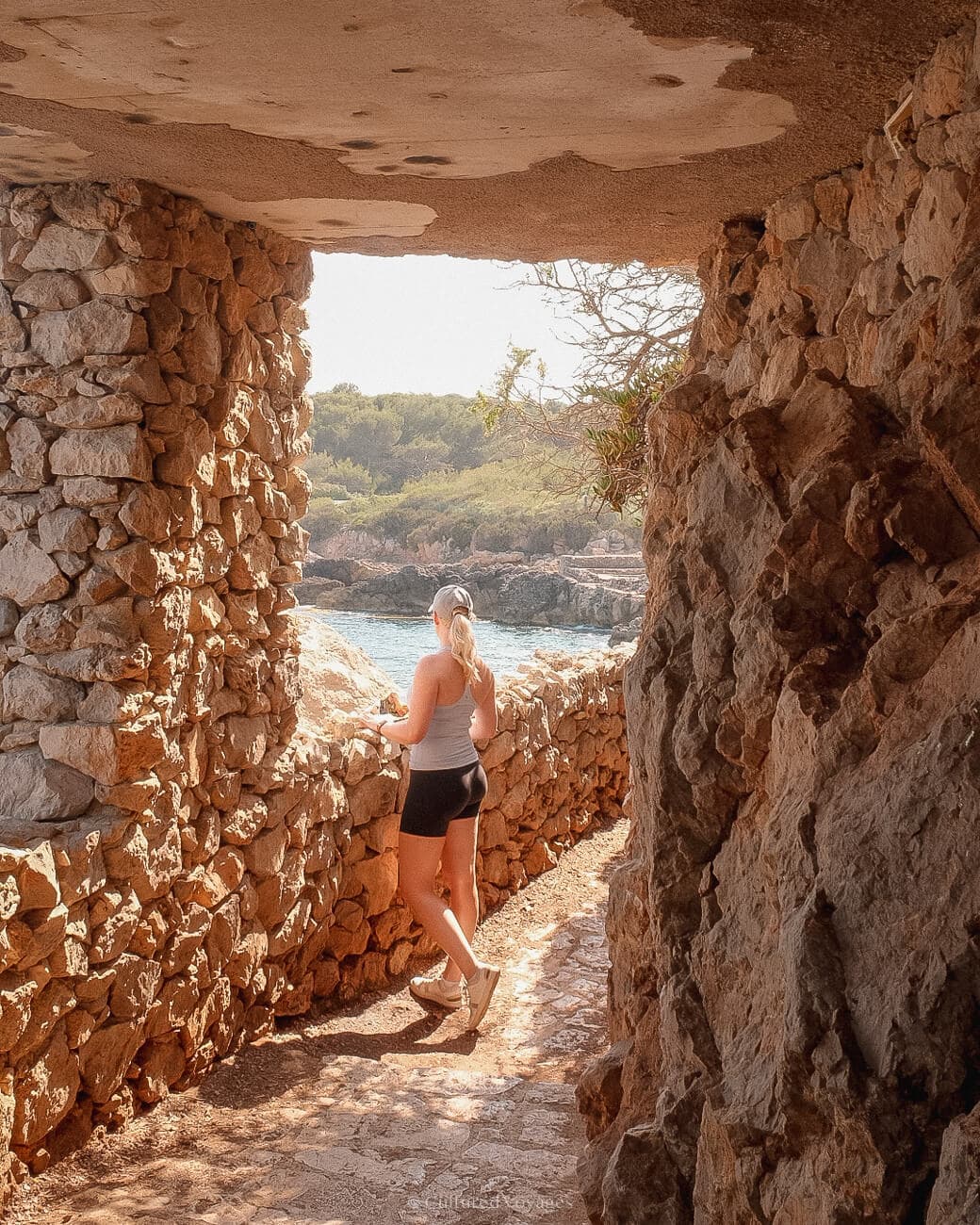 Me in a passage made by stone bricked walls and floors looking at the view of the sea and land filled with lush vegetation making it a worth it destination in Antibes.