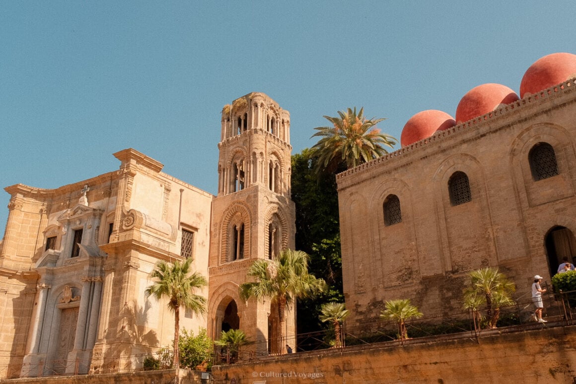 St. Mary of the Admiral church with grand pillars, bell tower. San Cataldo church boasts red domes and walls against clear blue skies. Must-visit in 3 day Palermo trip.