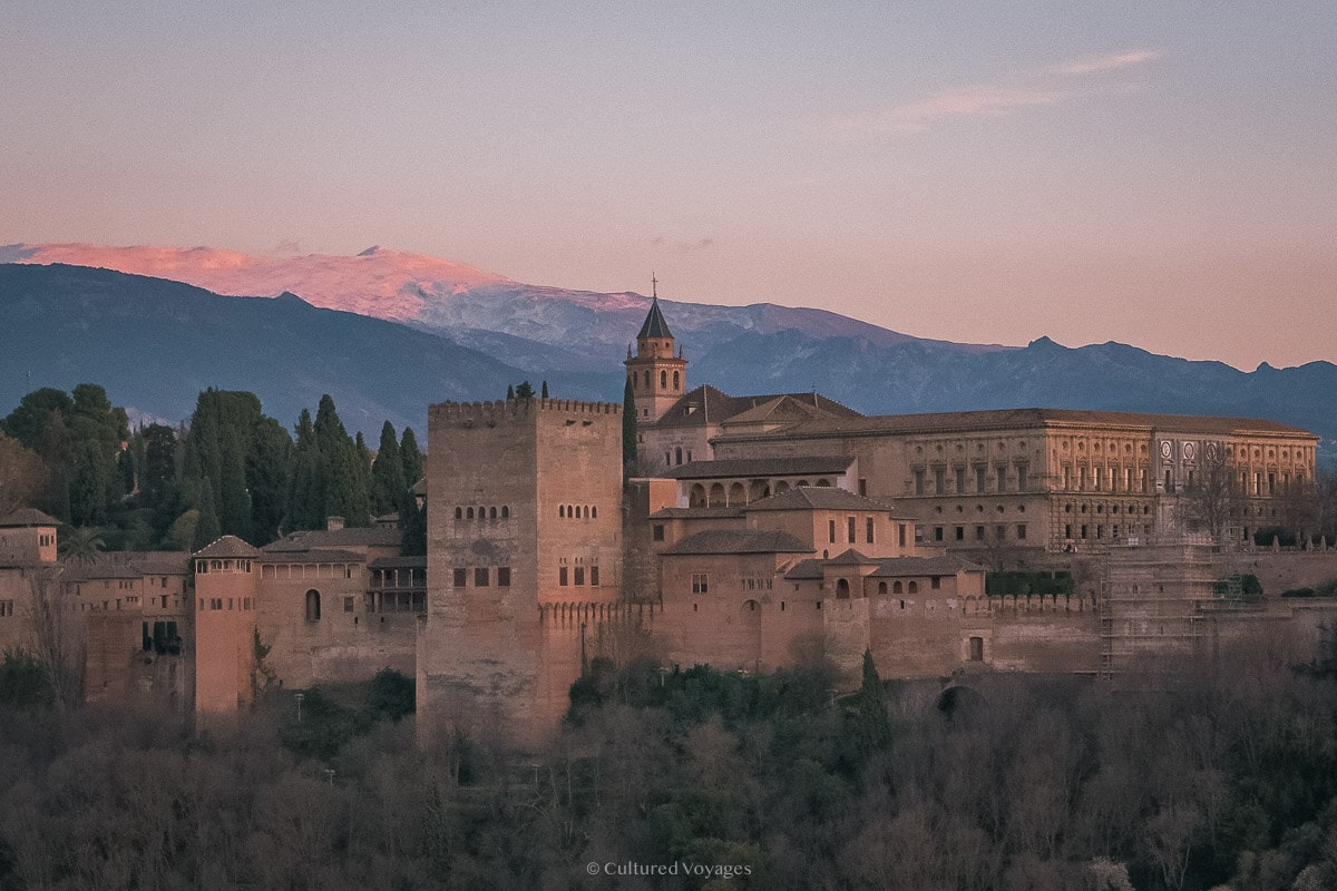 The Alhambra at sunset with snow on the Sierra Nevada beyond.