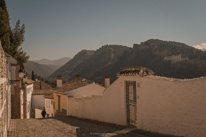 Whitewashed buildings along a hillside street in Granada’s Albaicín