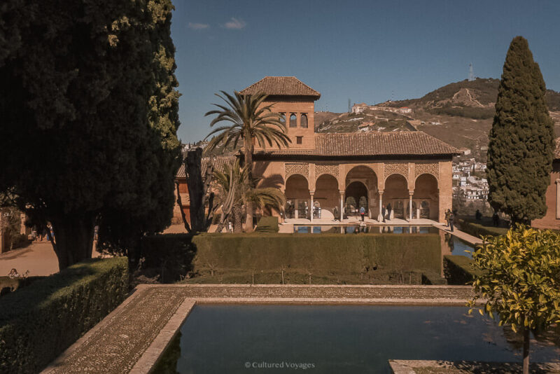 An arcaded pavilion reflected in a garden pool at the Alhambra