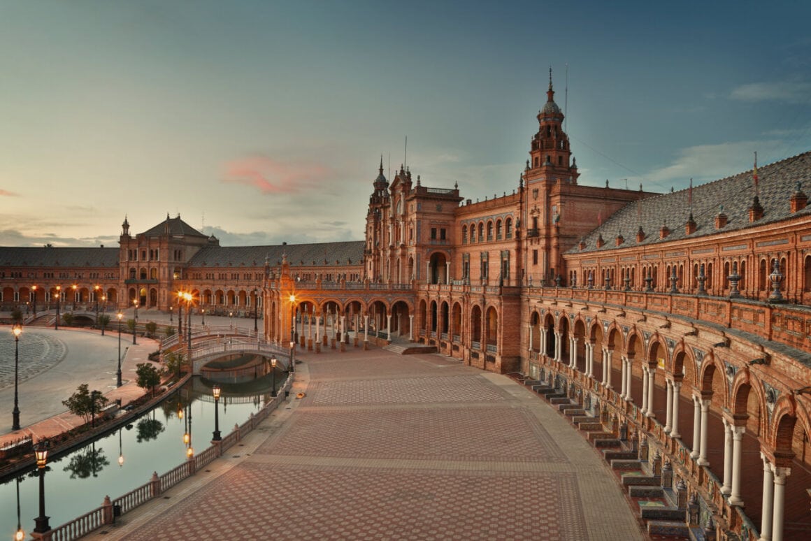 Empty street of the Plaza de Espaรฑa during sunset that Seville bike tours pass by