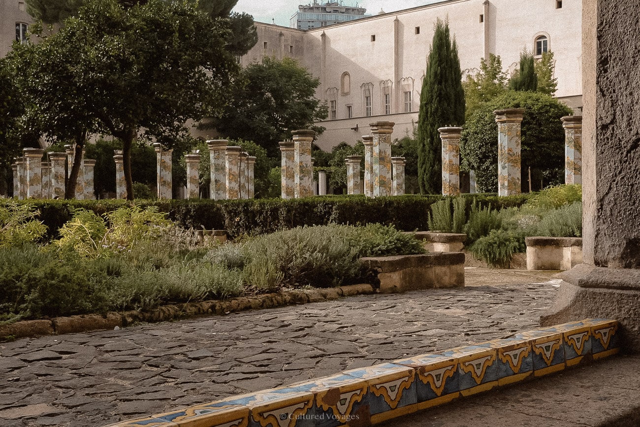 Painted majolica columns and tiled benches in the Santa Chiara cloister, Naples.