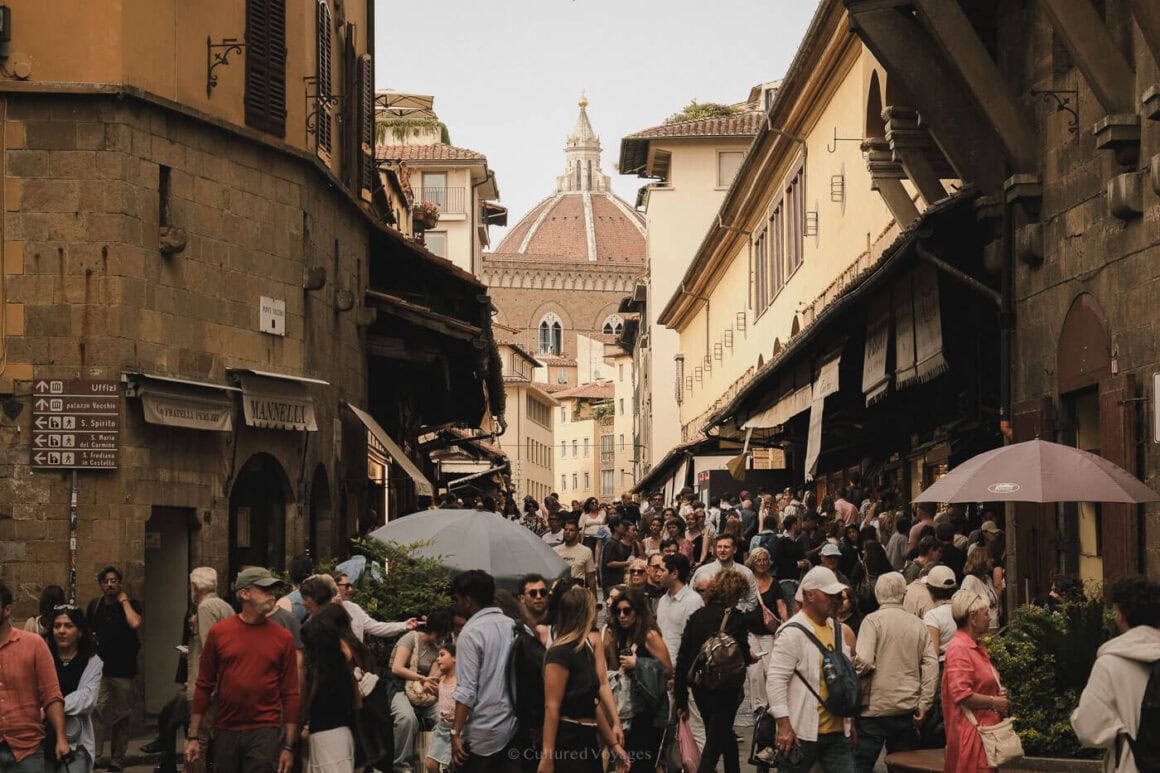 Moody aerial shot of Florence rooftops with Santa Croce prominently rising through the morning mistโcapturing the best time to visit Florence for dreamy cityscapes.