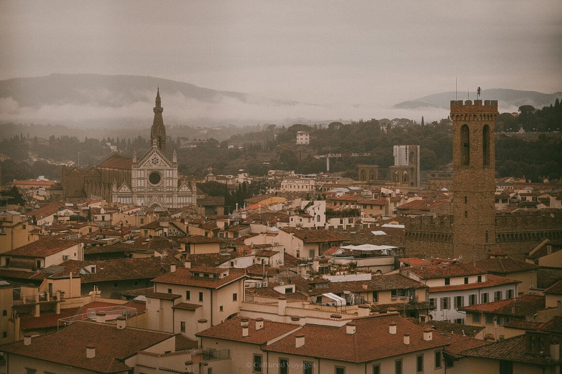 Moody aerial shot of Florence rooftops with Santa Croce prominently rising through the morning mistโcapturing the best time to visit Florence for dreamy cityscapes.