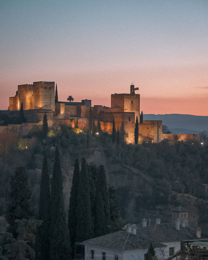 The Alhambra illuminated at dusk in Granada, Spain, a spectacular sight and one of the best European cities to visit in winter for its Moorish architecture and mild weather.