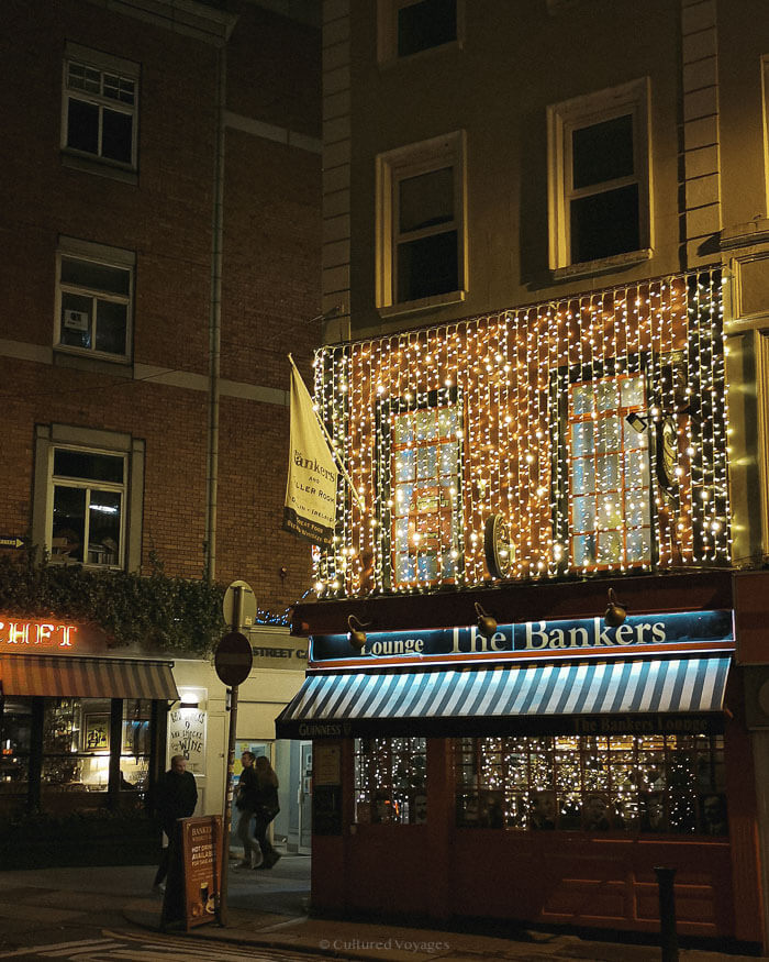A historic pub illuminated with cascading fairy lights on a winter evening in Dublin’s city centre.
