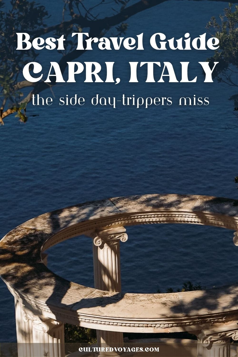 Capri Italy Travel Guide pinteres pin cover, A curved classical stone terrace with Ionic columns overlooks the deep blue Mediterranean Sea through shaded trees on Capri. The image promotes a Capri Italy Travel Guide.