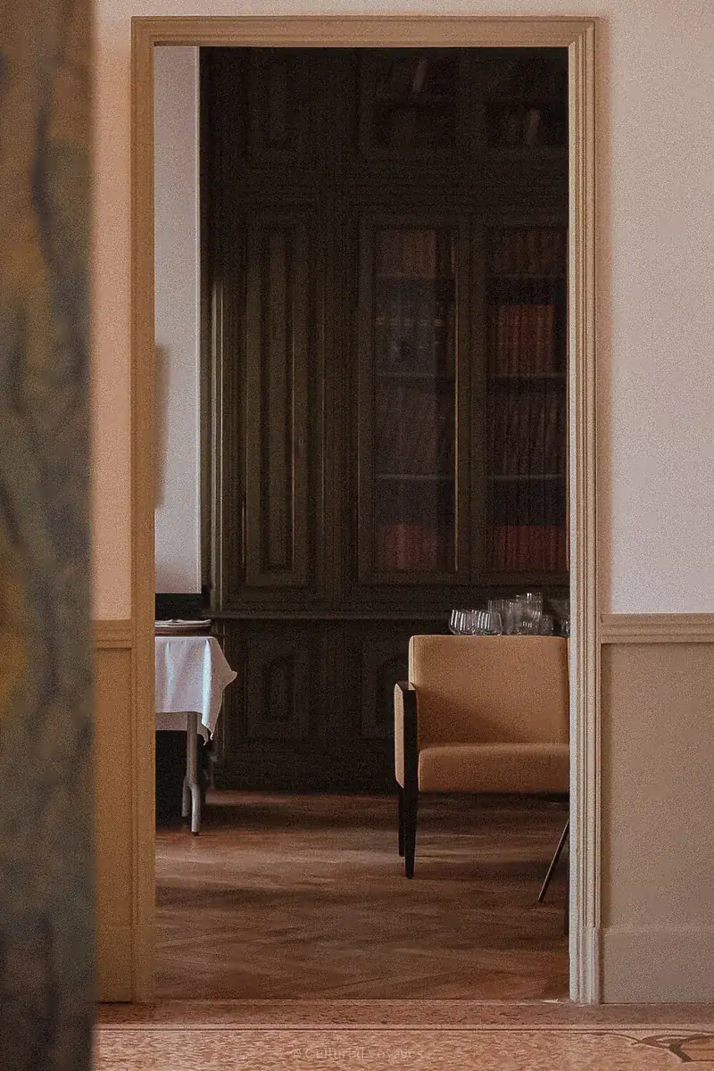 Doorway framing the wood-panelled dining room at Château des Fines Roches.