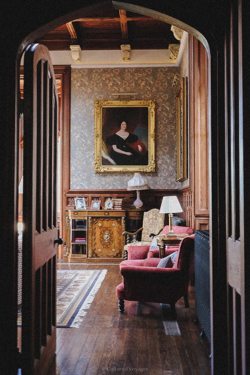 Arched doorway framing a portrait and upholstered chairs in a lounge at Markree Castle.