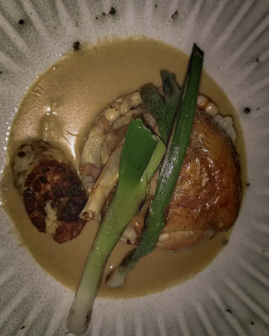 Roast chicken main course with charred spring onion