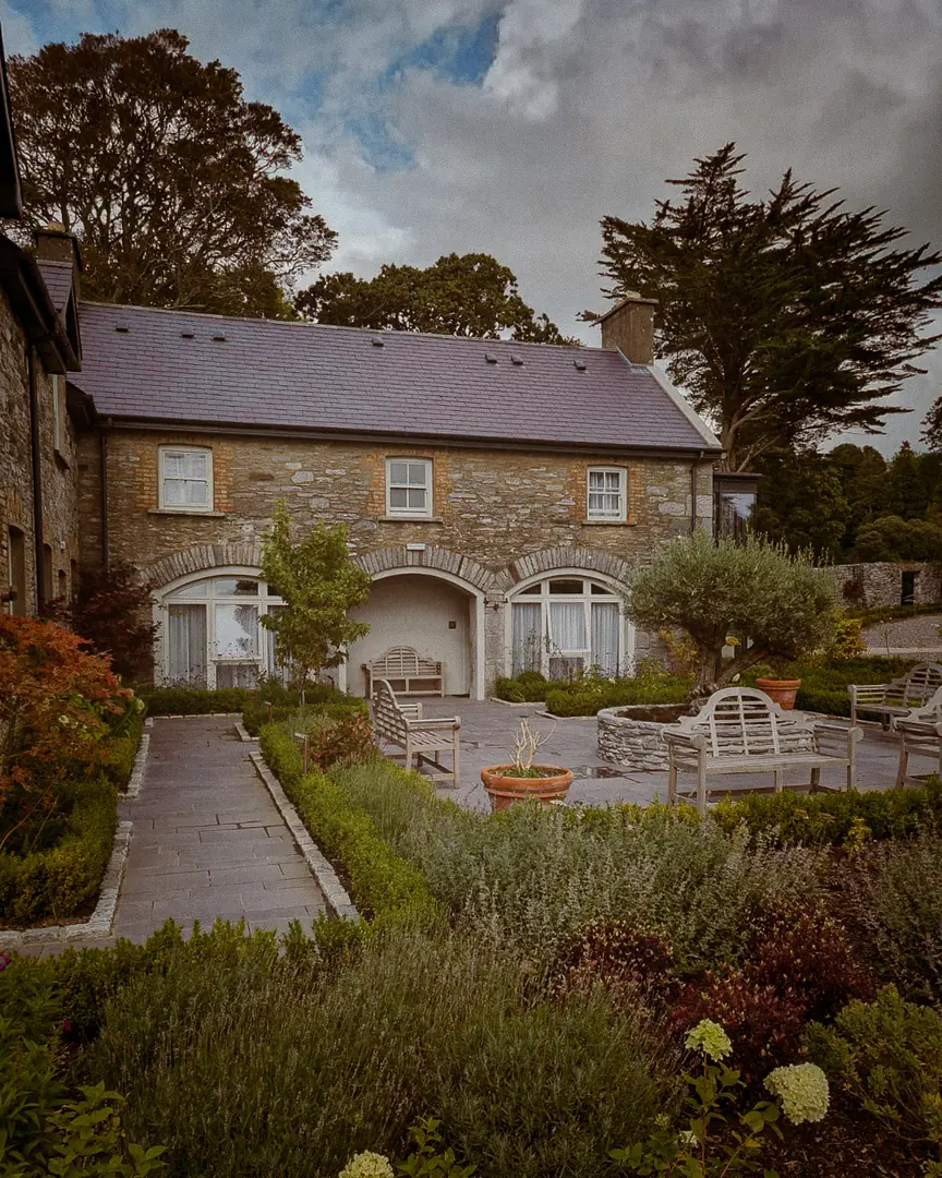 The stone Coach House and its planted courtyard garden