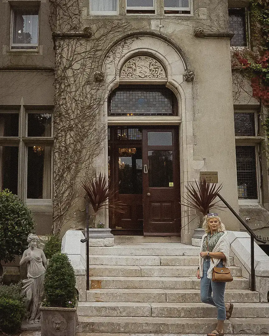 Isabelle on the stone entrance steps of Cahernane House